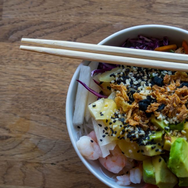 bowl containing hawaiian poke, avocado, shrimp